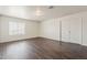 Spacious bedroom with hardwood floors, a large window and double door closet at 11016 W Griswold Rd, Peoria, AZ 85345