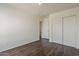 This bedroom boasts wood-look floors, a closet, an entry doorway, and neutral paint at 11016 W Griswold Rd, Peoria, AZ 85345
