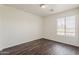 This bedroom offers wood-look floors, a window for natural light and an electrical outlet at 11016 W Griswold Rd, Peoria, AZ 85345