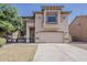Charming two-story home showcasing a well-manicured front yard and a spacious two-car garage at 11016 W Griswold Rd, Peoria, AZ 85345