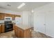 Functional kitchen with wooden cabinets, a center island, and modern white appliances at 11016 W Griswold Rd, Peoria, AZ 85345
