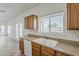 Bright kitchen featuring wooden cabinets, and a white sink at 11016 W Griswold Rd, Peoria, AZ 85345
