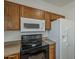 Updated kitchen features oak cabinets, sleek black appliances and modern countertops at 11016 W Griswold Rd, Peoria, AZ 85345