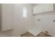 Functional laundry room with storage cabinets and ample space for appliances at 11016 W Griswold Rd, Peoria, AZ 85345