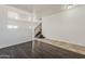 Open-concept living room with dark floors and an adjacent staircase at 11016 W Griswold Rd, Peoria, AZ 85345