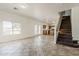 Spacious living room area showcases natural light, tile flooring, and access to the kitchen and staircase at 11016 W Griswold Rd, Peoria, AZ 85345