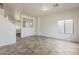 Bright living room with tile floors and plenty of natural light from the large window at 11016 W Griswold Rd, Peoria, AZ 85345