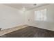 Bright living area with hardwood flooring, a large window, and a crisp white door at 11016 W Griswold Rd, Peoria, AZ 85345