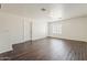 Bright living room with modern hardwood floors and natural light from the window at 11016 W Griswold Rd, Peoria, AZ 85345