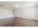 Open concept living room boasts fresh white paint and beautiful hardwood flooring at 11016 W Griswold Rd, Peoria, AZ 85345