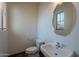 Cozy bathroom with white fixtures including toilet, sink, and oval mirror at 1244 S Tacoma --, Mesa, AZ 85209