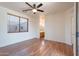 This bedroom has luxury vinyl plank flooring, a ceiling fan and an en suite bathroom at 1244 S Tacoma --, Mesa, AZ 85209