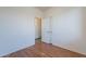 A simple bedroom has neutral paint, luxury vinyl plank flooring and a standard-sized door at 1244 S Tacoma --, Mesa, AZ 85209