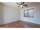 This simple bedroom has a ceiling fan, luxury vinyl plank flooring and a mini blind covered window at 1244 S Tacoma --, Mesa, AZ 85209