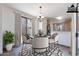 Virtually staged dining area with sliding glass door, chandelier, and neutral decor at 1244 S Tacoma --, Mesa, AZ 85209