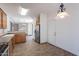 Open kitchen area with stainless steel appliances, tile flooring, and ample cabinets at 1244 S Tacoma --, Mesa, AZ 85209