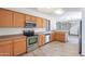 Functional kitchen with stainless steel appliances, wood cabinets, and tile flooring at 1244 S Tacoma --, Mesa, AZ 85209
