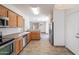 Well-lit kitchen features stainless appliances, wooden cabinets, and an easy flow to the dining area at 1244 S Tacoma --, Mesa, AZ 85209
