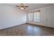 Living room featuring tile floors, two windows, ceiling fan, and a nearby door at 1244 S Tacoma --, Mesa, AZ 85209