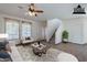 Virtually staged living room with tile floors, neutral furniture, and large windows at 1244 S Tacoma --, Mesa, AZ 85209