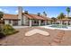 Inviting backyard with a pool, patio, and unique heart-shaped gravel design at 13631 N 70Th Dr, Peoria, AZ 85381