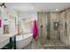 Bathroom featuring a soaking tub and glass-enclosed shower with stone floor at 13631 N 70Th Dr, Peoria, AZ 85381