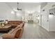 Expansive living room with a fireplace, large sectional sofa, and light grey flooring, and natural light at 13631 N 70Th Dr, Peoria, AZ 85381