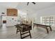 Open concept living room featuring grey flooring, natural light, and game tables for entertainment at 13631 N 70Th Dr, Peoria, AZ 85381