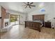 Spacious main bedroom featuring a brick fireplace, sliding glass doors, and a ceiling fan at 13631 N 70Th Dr, Peoria, AZ 85381