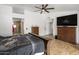 Comfortable main bedroom with wood flooring and a large TV at 13631 N 70Th Dr, Peoria, AZ 85381