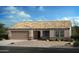 Charming single-story home featuring a beige exterior, arched entryway, and a two-car garage at 1416 E Edwin St, Casa Grande, AZ 85122