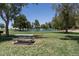 Beautiful community pond with a fountain, picnic tables, and grassy area for residents to enjoy at 1416 E Edwin St, Casa Grande, AZ 85122