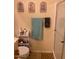Bathroom with a toilet, shelves, decorative wall art, a striped towel, and a glass-enclosed shower at 14950 W Mountain View Blvd # 5303, Surprise, AZ 85374