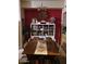 Cozy dining area with a wood table, bright red wall, and decorative shelving at 14950 W Mountain View Blvd # 5303, Surprise, AZ 85374