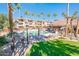 Community pool with lounge chairs, dining area, grilling station and lush landscaping at 14950 W Mountain View Blvd # 5303, Surprise, AZ 85374