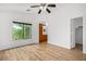Bright bedroom with archway to bathroom, wood floors, large windows, and neutral walls at 16620 S 48Th St # 79, Phoenix, AZ 85048
