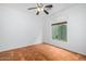 Neutral bedroom with large window, ceiling fan, and tile flooring at 16620 S 48Th St # 79, Phoenix, AZ 85048
