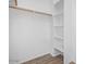 Bright closet with laminate floors, a wooden rod, and white shelving at 16620 S 48Th St # 79, Phoenix, AZ 85048