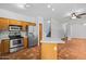 Bright kitchen with stainless appliances, an island, and views to stairs and dining area at 16620 S 48Th St # 79, Phoenix, AZ 85048