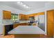 Traditional kitchen with wooden cabinets, stainless steel appliances, and a bright white countertop island at 16620 S 48Th St # 79, Phoenix, AZ 85048