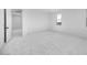 Bright, open bedroom featuring plush gray carpet and a nice view from the window at 16810 W Yucatan Dr, Surprise, AZ 85388