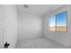 Bright bedroom features neutral carpet, white walls and trim, and natural light from a large window at 16810 W Yucatan Dr, Surprise, AZ 85388