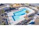 Aerial view of community pool with palm trees, lounge chairs, and seating areas at 16810 W Yucatan Dr, Surprise, AZ 85388