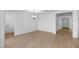 Bright, open dining room with a modern chandelier and wood-look tile flooring at 16810 W Yucatan Dr, Surprise, AZ 85388