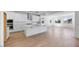 Bright, open kitchen with white cabinets, stainless steel appliances, and a large center island, seamlessly flowing into the living area at 16810 W Yucatan Dr, Surprise, AZ 85388