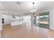 Open concept kitchen and dining area with white cabinets, island, and stainless steel appliances at 16810 W Yucatan Dr, Surprise, AZ 85388