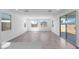 Bright and airy living area with modern flooring, large windows, and a sliding door to the backyard, creating an inviting atmosphere at 16810 W Yucatan Dr, Surprise, AZ 85388