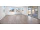 A spacious living area with large windows, sliding glass doors, and modern flooring, offering ample natural light and easy outdoor access at 16810 W Yucatan Dr, Surprise, AZ 85388