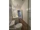 Bright bathroom featuring double sinks, wood-look flooring, and a toilet at 1730 W Pollack St, Phoenix, AZ 85041