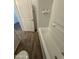 Bathroom view with a toilet, bathtub, and doorway that showcases the wood-look tile flooring at 1730 W Pollack St, Phoenix, AZ 85041